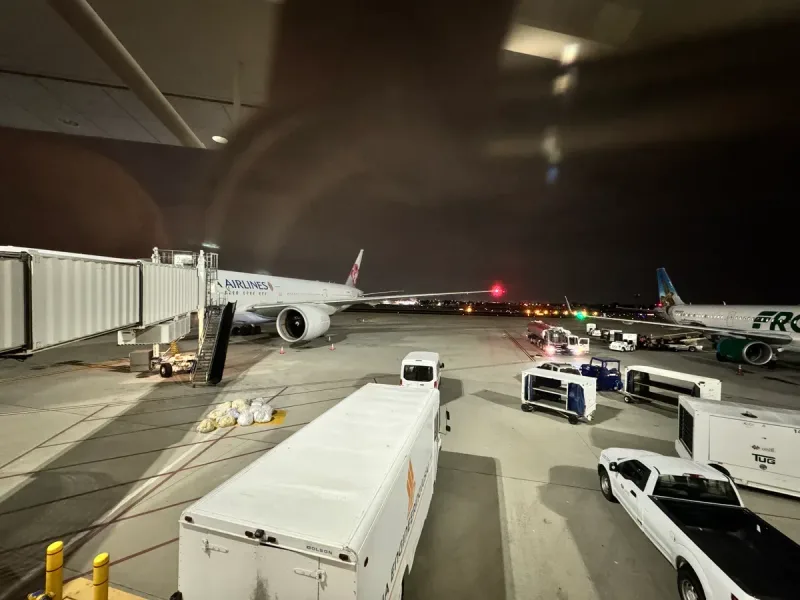Japan Airlines plane at airport gate at night
