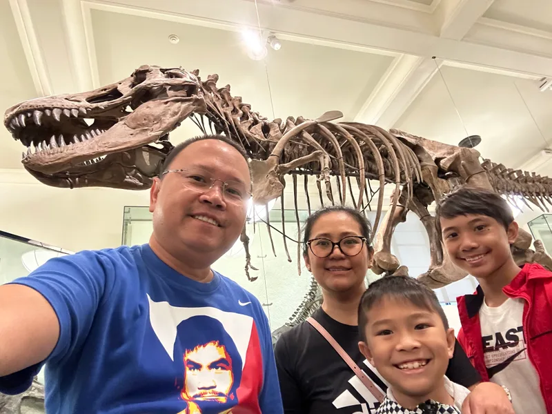 Family selfie at American Museum of Natural History with T-Rex skeleton