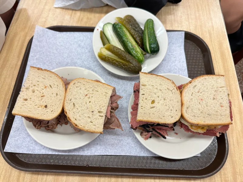 Pastrami sandwiches on rye with pickles at Katz's Delicatessen