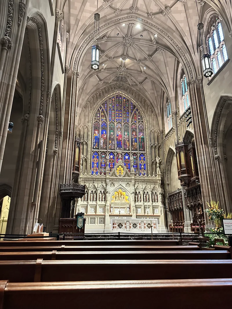 Ornate interior of Trinity Church on Wall Street with stained-glass window