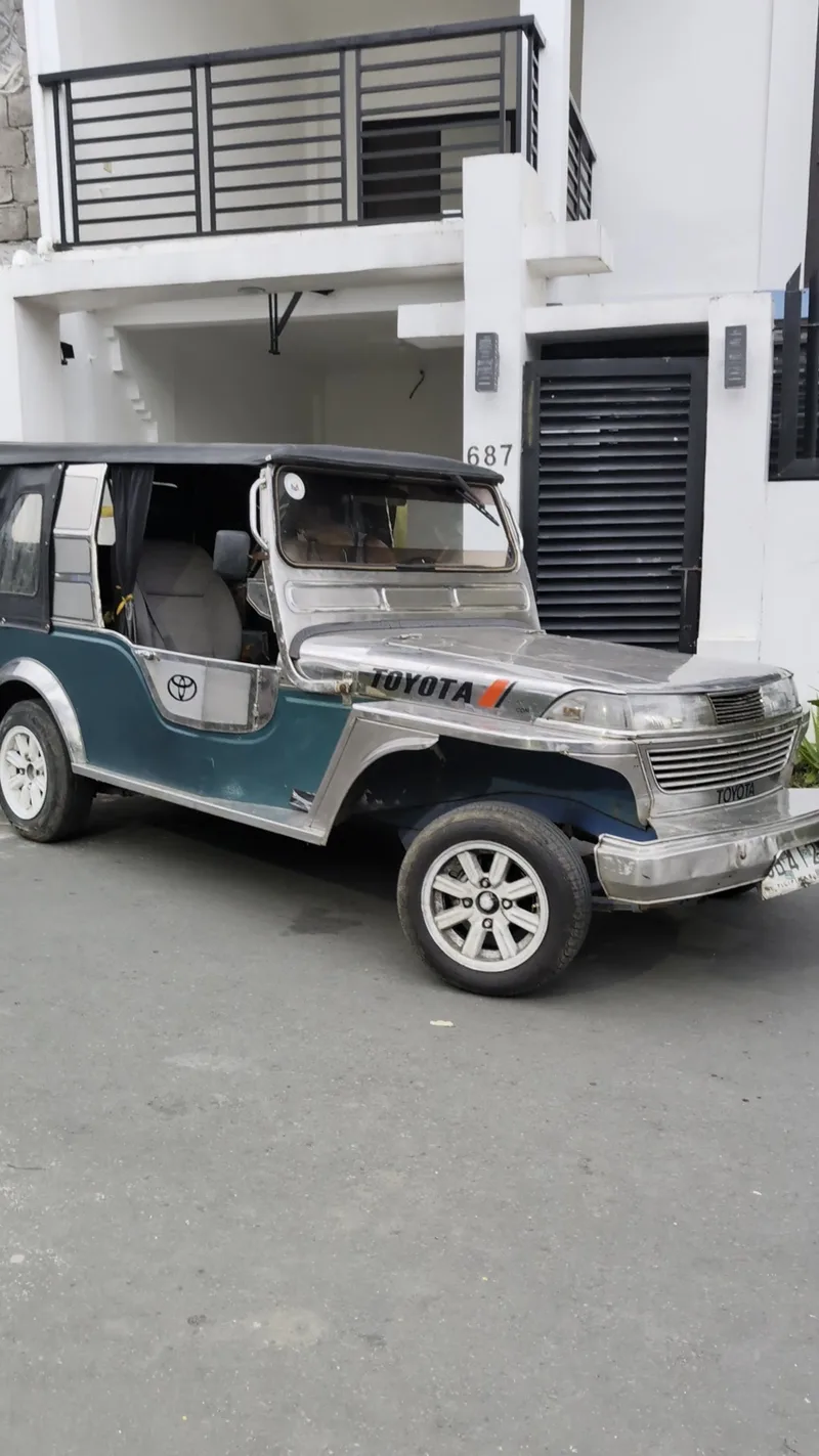 Teal and silver Toyota Owner Type Jeep parked in front of a house numbered 687 in Liliw, Laguna, Philippines.