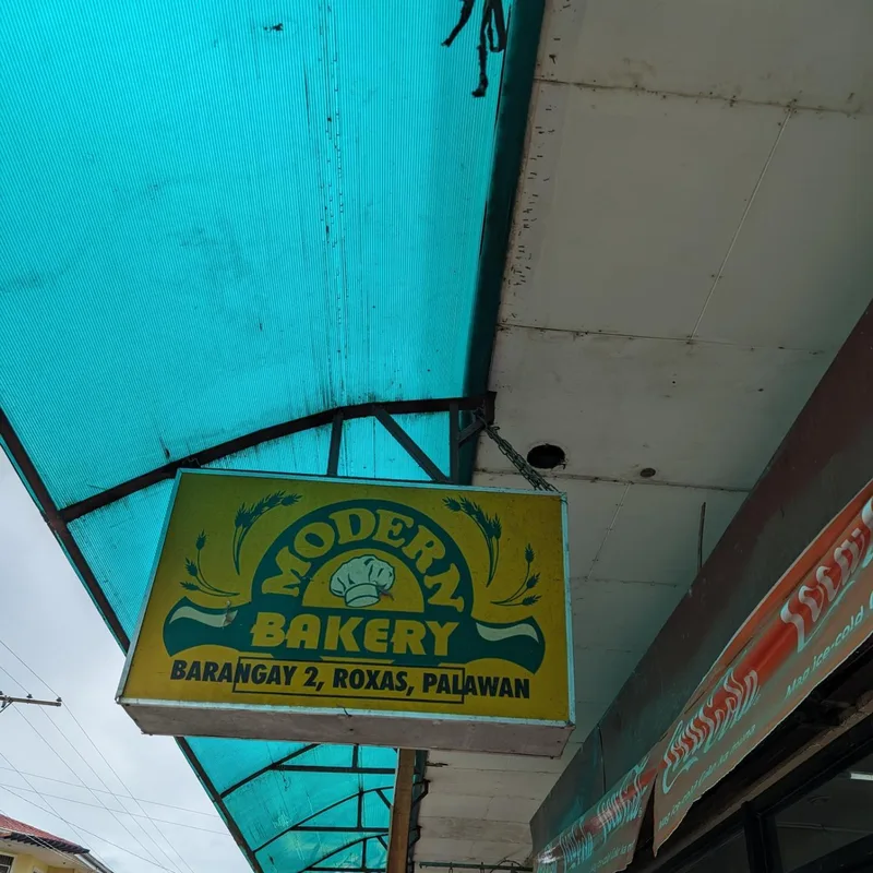 Modern Bakery on the main highway in Barangay 2, Roxas, Palawan Modern Bakery yellow and blue sign under a blue corrugated awning in Barangay 2 Roxas Palawan Philippines
