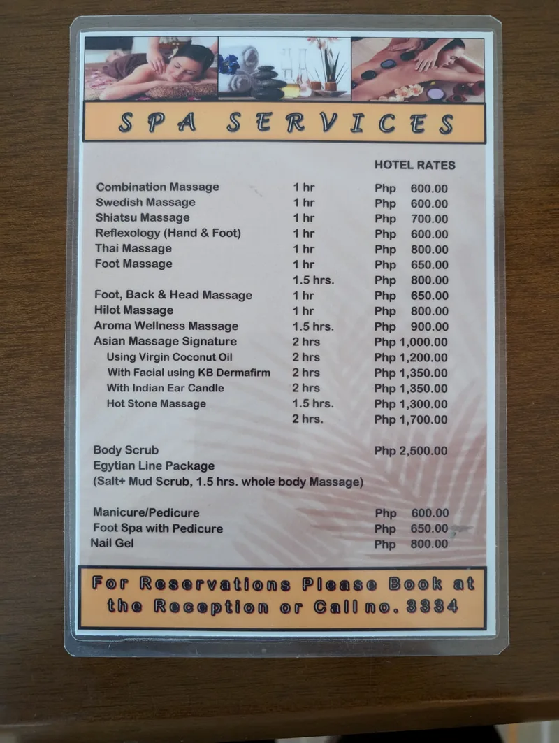 ₱600 for a massage — you're not going to find that back home Laminated spa services menu showing massage and beauty treatment prices in Philippine Pesos at a hotel in Puerto Princesa Palawan
