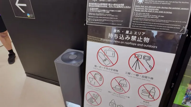 The prohibited items sign at Shibuya Sky, Shibuya, Tokyo, Japan — tripods and selfie sticks are not allowed on the rooftop Shibuya Sky sign listing prohibited items including tripods, selfie sticks, and food for rooftop access, Tokyo, Japan.