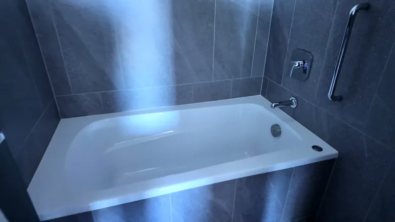 Deep soaking bathtub in a modern bathroom at Hotel Indigo Shibuya, Tokyo, Japan