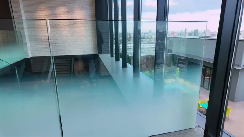 Modern glass railing interior with outdoor terrace seating at Hotel Indigo Shibuya, Tokyo, Japan